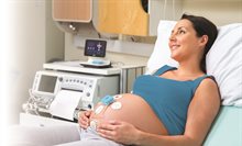 Monica Healthcare - mother in bed wearing monitoring device