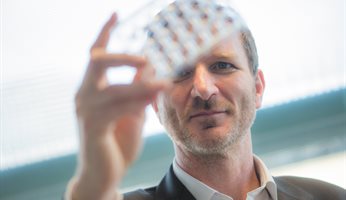 Morgan Alexander holding a microplate
